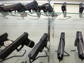This Wednesday, June 29, 2016, photo shows guns on display at a gun store in Miami. After a gunman killed more than 50 people in Las Vegas in the nation's latest mass shooting, stocks in the gun industry rose, Monday, Oct. 2, 2017. (AP Photo/Alan Diaz)