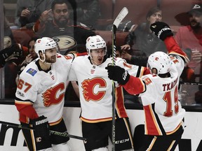 Members of the Calgary Flames celebrate Mikael Backlund's (11) goal against the Anaheim Ducks on Oct. 9.