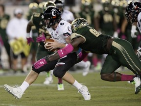 Cincinnati quarterback Hayden Moore (8) is sacked by South Florida defensive end Mike Love (98) during the first half of an NCAA college football game Saturday, Oct. 14, 2017, in Tampa, Fla. (AP Photo/Jason Behnken)