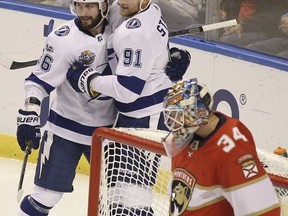 Tampa Bay Lightning's Nikita Kucherov, top left, of Russia, celebrates with teammate Steven Stamkos (91) after scoring a goal during the first period of an NHL hockey game against Florida Panthers goalie James Reimer (34), Monday, Oct. 30, 2017, in Sunrise, Fla. (AP Photo/Luis M. Alvarez)
