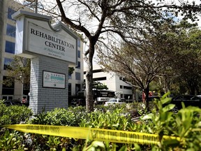 FILE- This Sept. 13, 2017, file photo, police surround the Rehabilitation Center in Hollywood Hills, Fla. At first there was no hint of distress in the 911 calls, no sense of a crisis unfolding. But newly released emergency calls from the sweltering Florida nursing home that lost its air conditioning to Hurricane Irma showed staffers becoming increasing agitated by a disaster that would eventually claim 14 elderly lives. (John McCall/South Florida Sun-Sentinel via AP, File)