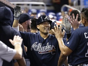 Atlanta Braves' Kurt Suzuki is congratulated after hitting a two-run home run during the third inning of a baseball game against the Miami Marlins, Sunday, Oct. 1, 2017, in Miami. (AP Photo/Lynne Sladky)