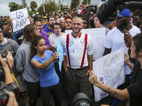 Protesters confront a man wearing a shirt with swastikas outside a University of Florida auditorium where white nationalist Richard Spencer was preparing to speak, Thursday, Oct. 19, 2017 in Gainesville, Fla. (Will Vragovic/Tampa Bay Times via AP)