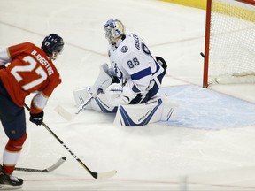 Florida Panthers center Nick Bjugstad (27) scores a goal against Tampa Bay Lightning goalie Andrei Vasilevskiy (88) during the second period of an NHL hockey game, Saturday, Oct. 7, 2017 in Sunrise, Fla. (AP Photo/Wilfredo Lee),