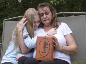 Denise Lane and her daughter Megan sit with the urn containing the ashes of her son Shawn in Innisfil, Ont. on Friday October 6, 2017. Denise Lane searches her mind for fond memories of her son, but she has trouble retrieving them. No Christmases, no birthdays. It's hard to remember the good times. Shawn Kelly Jr. died of a fentanyl overdose in Innisfil, Ont., about an hour's drive north of Toronto.