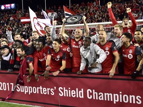 The Toronto FC celebrate with the Supporters' Shield following their win over the Montreal Impact in MLS soccer action in Toronto on Sunday, October 15, 2017. THE CANADIAN PRESS/Frank Gunn