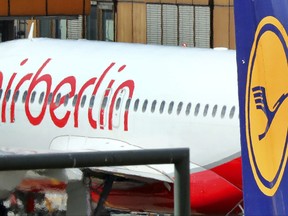 FILE - In the Sept. 21, 2017 file photo an Air Berlin plane sits behind a Lufthansa plane in Tegel airport in Berlin. (Wolfgang Kumm/dpa via AP)