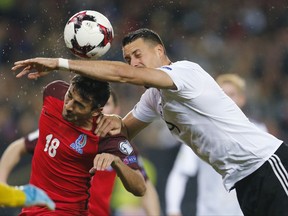 Azerbaijan's Tamkin Khalilzade, left, and Germany's Sandro Wagner go for a header during the 2018 World Cup qualifying Group C soccer match between Germany and Azerbaijan in Kaiserslautern, Germany, Sunday, Oct. 8, 2017.(AP Photo/Michael Probst)