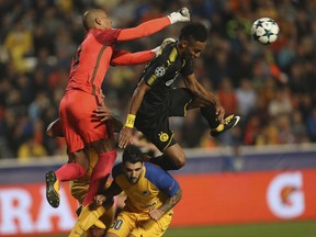 APOEL goalkeeper Boy Waterman, left, and Dortmund's Pierre-Emerick Aubameyang challenge for the ball during the Champions League Group H soccer match between APOEL Nicosia and Borussia Dortmund at GSP stadium, in Nicosia, Cyprus, on Tuesday, Oct. 17, 2017. (AP Photo/Petros Karadjias)