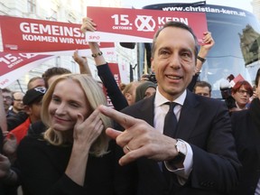 Austrian Chancellor Christian Kern, right, and his wife Eveline Steinberger-Kern arrive for a campaign rally of the Social Democratic party in Vienna, Austria, Friday, Oct. 13, 2017. Austria will hold national elections on Sunday, Oct. 15, 2017. (AP Photo/Ronald Zak)