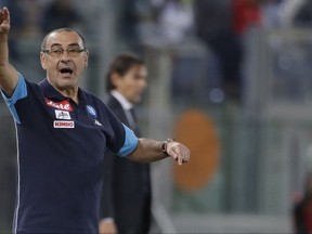 FILE - In this Wednesday, Sept. 20, 2017 file photo, Napoli coach Maurizio Sarri gestures during a Serie A soccer match between Lazio and Napoli, at the Rome Olympic stadium. Maurizio Sarri is approaching saint-like status with Napoli leading the league, Allegri has led Juventus to two Champions League finals in three years, and Luciano Spalletti has restored confidence at Inter Milan. (AP Photo/Alessandra Tarantino, File)