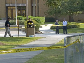 In this Sept. 14, 2017, photo, Louisiana State University Police investigate the death of Louisiana State University student Maxwell Gruver as a possible fraternity hazing incident, on campus fraternity house, Phi Delta Theta in Baton Rouge, La.