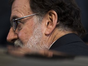 Spain's Prime Minister Mariano Rajoy enters his car as he leaves the Spanish parliament in Madrid, Wednesday, Oct. 25, 2017. Prime Minister Rajoy says the government's plans to take unprecedented control of Catalonia's key affairs and halt that region's push for independence are "exceptional" and he hopes they will not last long.  (AP Photo/Francisco Seco)