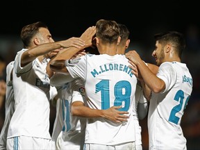 Real Madrid players celebrate their side's second goal against Fuenlabrada during a Spanish Copa del Rey round of 32 first leg soccer match between Fuenlabrada and Real Madrid at the Fernando Torres stadium in Fuenlabrada, outside Madrid, Thursday, Oct. 26, 2017. Real Madrid won 2-0. (AP Photo/Francisco Seco)
