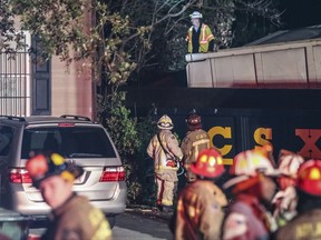 Emergency personnel work as the scene of a train derailment early Thursday, Oct. 5, 2017, in Atlanta. Authorities say the freight train has crashed into the bedroom of a home, sending a man inside to a hospital. (John Spink/Atlanta Journal-Constitution via AP)