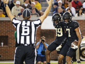 Wake Forest's Scotty Washington, right, celebrates with teammate Greg Dortch after scoring a touchdown in the first quarter of an NCAA college football game against Georgia Tech in Atlanta, Saturday, Oct. 21, 2017. (AP Photo/David Goldman)