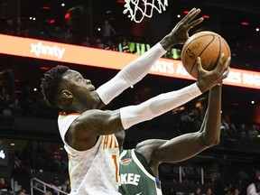 Atlanta Hawks guard Dennis Schroder (17) goes to the basket from the baseline as Milwaukee Bucks forward Thon Maker defends during the first half of an NBA basketball game, Sunday, Oct. 29, 2017, in Atlanta. (AP Photo/John Amis)