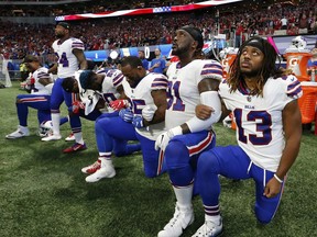 Buffalo Bills players take a knee during the national anthem before the first half of an NFL football game between the Atlanta Falcons and the Buffalo Bills, Sunday, Oct. 1, 2017, in Atlanta. (AP Photo/John Bazemore)