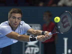 Croatia's Borna Coric returns a ball to Switzerland's Henri Laaksonen during their first round match at the Swiss Indoors tennis tournament at the St. Jakobshalle in Basel, Switzerland, on Wednesday, Oct. 25, 2017. (Georgios Kefalas/Keystone via AP)
