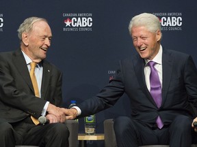 Former U.S. president Bill Clinton, right, and former Canadian prime minister Jean Chretien laugh during a discussion on their time in office during an event to mark Canada's 150th anniversary in Montreal, Wednesday, October 4, 2017. THE CANADIAN PRESS/Graham Hughes