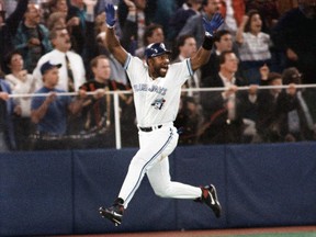 In this Oct. 23, 1993 file photo, Toronto Blue Jays first baseman Joe Carter celebrates his World Series-winning home run against the Philadelphia Phillies.