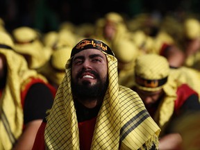 Lebanese Shiite supporters of Hezbollah cry as listen to the story of Imam Hussein, during activities marking the holy day of Ashoura, in southern Beirut, Lebanon, Sunday, Oct. 1, 2017. Ashoura is the annual Shiite Muslim commemoration marking the death of Imam Hussein, the grandson of the Prophet Muhammad, at the Battle of Karbala in present-day Iraq in the 7th century. (AP Photo/Hassan Ammar)