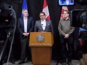 Calgary Mayor Naheed Nenshi, centre, speaks to reporters about the city's position on the Saddledome in Calgary on Sept. 15, 2017. The tension between the Calgary Flames and city council over a new arena looks to continue unabated with the re-election of Mayor Naheed Nenshi for a third term.