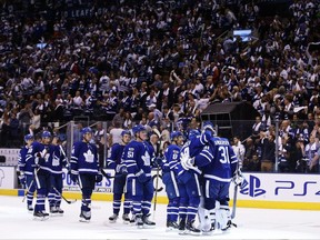Toronto Maple Leafs players celebrate their win over the New York Rangers on Oct. 7.
