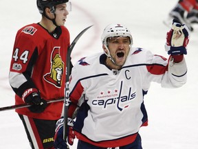 Alex Ovechkin of the Washington Capitals celebrates his third goal of the game in front of the Senators' Jean-Gabriel Pageau during the third period in Ottawa on Thursday night.