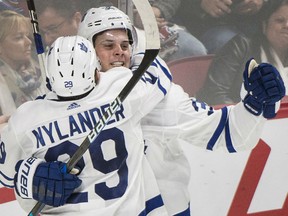 Auston Matthews celebrates with Toronto Maple Leafs teammate William Nylander after scoring the overtime winning goal against the Canadiens, in Montreal on Saturday night.