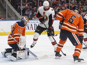 Ottawa Senators forward Zack Smith (centre) tries to tip the puck past Edmonton Oilers goalie Cam Talbot on Oct. 14.