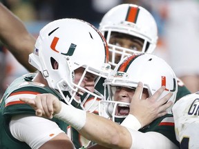 Miami punter Jack Spicer, left, congratulates place kicker Michael Badgley after Badgley kicked a field goal with seconds remaining in the second half of an NCAA College football game, Saturday, Oct. 14, 2017 in Miami Gardens, Fla. Miami defeated Georgia Tech 25-24. (AP Photo/Wilfredo Lee)