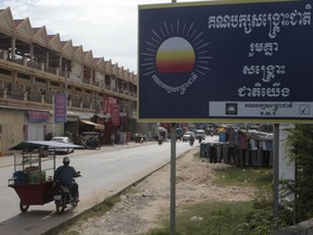 A signboard logo of the opposition Cambodia Rescue Party, CNRP, sticks on a sidewalk at the outskirts of Phnom Penh, Cambodia, Friday, Oct. 6, 2017. Cambodia's government on Friday took the initial legal steps seeking to dissolve the country's major opposition party, the latest in a series of moves to gain an advantage ahead of next year's general election. (AP Photo/Heng Sinith)