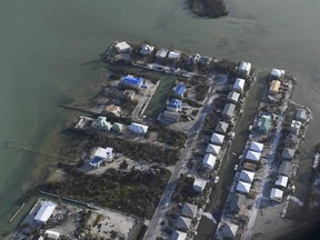 In this Sept. 11, 2017, photo, damaged houses are shown in the aftermath of Hurricane Irma in the Florida Keys. The hurricanes that battered Texas and Florida likely spawned the worst disaster-created housing crunch since Hurricane Katrina left hundreds of thousands of Gulf Coast residents without homes more than a decade ago.