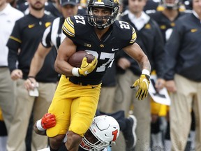 Iowa defensive back Amani Hooker (27) is tackled by Illinois linebacker Dele Harding (9) during a fake punt in the first half of an NCAA college football game, Saturday, Oct. 7, 2017, in Iowa City, Iowa. (AP Photo/Charlie Neibergall)