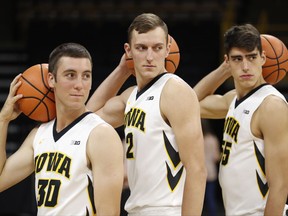 Iowa freshmen Connor McCaffery, from left, Jack Nunge and Luka Garza pose for photographers during Iowa's annual college basketball media day, Monday, Oct. 16, 2017, in Iowa City, Iowa. (AP Photo/Charlie Neibergall)