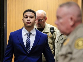 Jorge Sanders-Galvez, left, is escorted from an elevator to the South Lee County Courtroom, during jury selection for his first-degree murder trial, Wednesday, Oct. 25, 2017 in Keokuk, Iowa. Sanders-Galvez, is one of two men accused of killing Kedarie Johnson, 16, of Burlington, Iowa.  (Zach Boyden-Holmes/The Des Moines Register via AP)