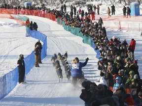 Race veteran Linwood Fiedler waves to the fans while dropping onto the Chena River during the restart of the Iditarod Sled Dog Race in front of Pike's Waterfront Lodge, Monday, March 6, 2017 in Fairbanks, Alaska.