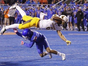 Wyoming running back Trey Woods (6) is upended by Boise State cornerback DeAndre Pierce (4) during the first half of an NCAA college football game in Boise, Idaho, on Saturday, Oct. 21, 2017. (AP Photo/Otto Kitsinger)