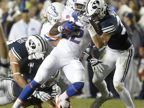 Boise State's Alexander Mattison (22) is brought down by the BYU defense during an NCAA college football game Friday, Oct. 6, 2017, in Provo, Utah. (Drew Nash/The Times-News via AP)