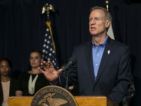 Illinois Gov. Bruce Rauner announces at a news conference that he'll sign legislation allowing state health insurance and Medicaid coverage for abortions, Thursday, Sept. 28, 2017 in Chicago. The move ended months of speculation after the Republican reversed his stance on the issue last spring. (Ashlee Rezin/Chicago Sun-Times via AP)
