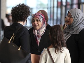 Supporters of Abdella Ahmad Tounisi leave the Dirksen U.S. Courthouse in Chicago on Thursday, Oct. 19, 2017, after Tounisi was sentenced to 15 years in prison for attempting to join an al-Qaida-linked group fighting Bashar Assad's regime in Syria. (Terrence Antonio James/Chicago Tribune via AP)