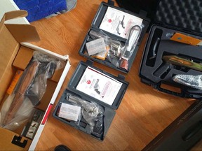 This April 2015 photo provided by the U.S. Attorney's Office in Chicago shows several guns that were stolen by street gangs from a train stopped in Chicago. A Federal judge will sentence a purported street-gang member for a heist of 100 newly minted guns that put a focus on security at a major Norfolk Southern rail yard in a high-crime part of the city. Andrew Shelton's sentencing Tuesday, Oct. 3, 2017, is for the theft of guns off a train stopped overnight at the South Side facility. (U.S. Attorney's Office in Chicago via AP)