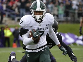 Michigan State wide receiver Cody White (7) carries the ball past Northwestern safety Godwin Igwebuike during the first half of an NCAA college football game in Evanston, Ill., Saturday, Oct. 28, 2017. (AP Photo/Nam Y. Huh)