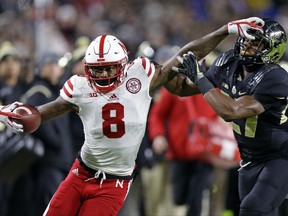 Nebraska wide receiver Stanley Morgan Jr. (8) pushes off the tackle of Purdue safety Navon Mosley (27) during the first half of an NCAA college football game in West Lafayette, Ind., Saturday, Oct. 28, 2017. (AP Photo/Michael Conroy)