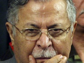 FILE - In this Aug 2, 2006 file photo, Iraq's President Jalal Talabani pauses after announcing new security plans in Baghdad, Iraq. Talabani, a lifelong fighter for Iraq's Kurds who rose to become the country's president, presenting himself as a unifying father figure to temper the potentially explosive hatreds among Kurds, Shiites and Sunnis has died in a Berlin hospital at the age of 83. (AP Photo/Khalid Mohammed, File)