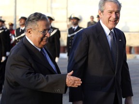 FILE - In this Dec. 14, 2008 file photo, then U.S. President George W. Bush, right, walks with Iraqi President Jalal Talabani in Baghdad, Iraq. Talabani, a lifelong fighter for Iraq's Kurds who rose to become the country's president, presenting himself as a unifying father figure to temper the potentially explosive hatreds among Kurds, Shiites and Sunnis has died in a Berlin hospital at the age of 83. (AP Photo/Evan Vucci, File)