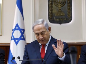 Israeli Prime Minister Benjamin Netanyahu chairs the weekly cabinet meeting at his office in Jerusalem, Sunday, Oct. 29, 2017.  On Sunday Israeli officials said that under pressure from the United States, Israel has delayed a bill that would connect a number of West Bank settlements to Jerusalem. (Gali Tibbon, Pool via AP)