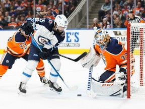 Mathieu Perreault of the Winnipeg Jets is foiled by Edmonton Oilers' goaltender Cam Talbot from close in during NHL action Monday night at Rogers Place. The Jets were 5-2 winners.