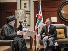 Influential Iraqi Shiite cleric, Muqtada al-Sadr, meets with Jordan's King Abdullah II at the royal palace in Amman, Jordan, Monday, Oct. 23, 2017. The king met with al-Sadr as the United States stepped up efforts to contain the influence of Shiite-led Iran in the Middle East. (Jordanian Royal Court via AP)